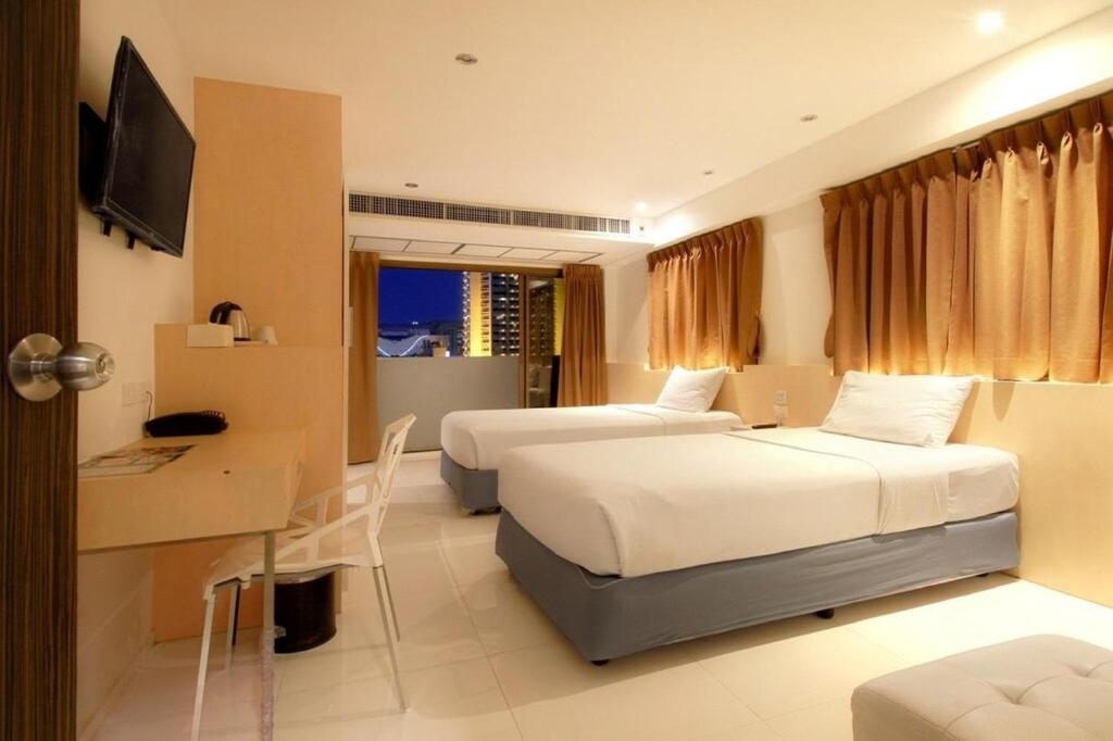 Postel nebo postele na pokoji v ubytování Ten Stars Hotel