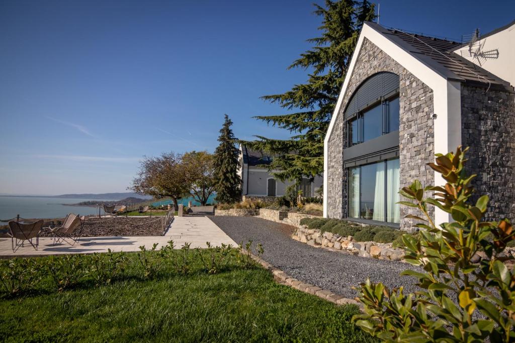 a stone house with a view of the ocean at Villa Salve in Badacsonytomaj