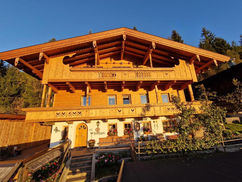 a large wooden house with a wooden roof at Haus Frei-Nagele in Alpbach