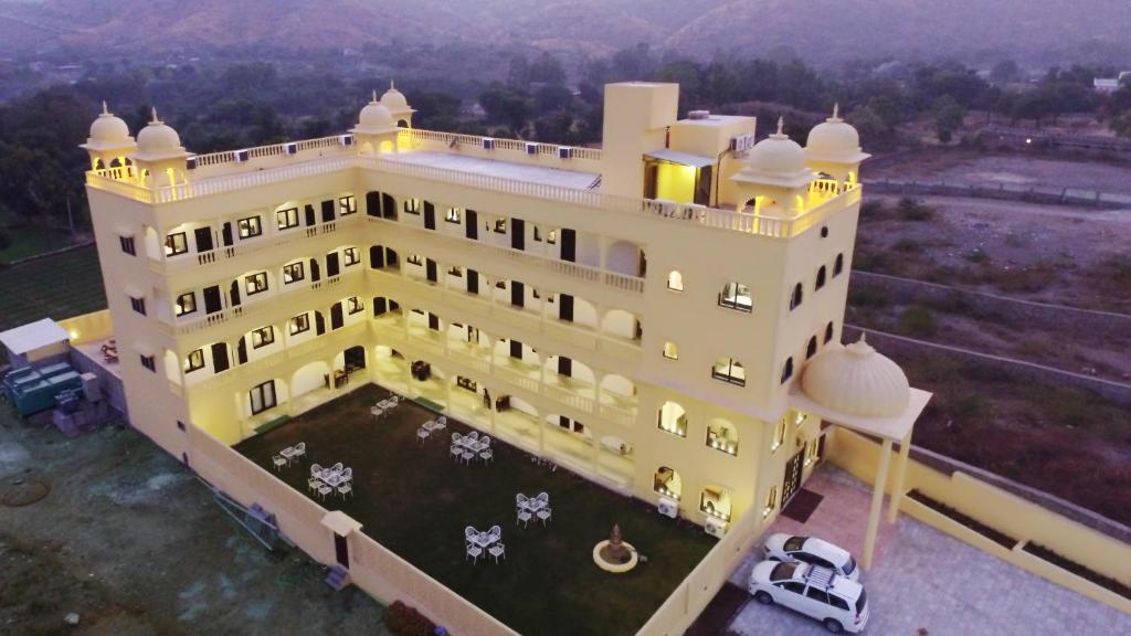 an aerial view of a large yellow building at Atulya Niwas in Udaipur