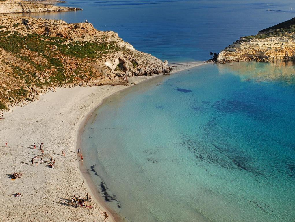 an aerial view of a beach with people on it at Dammusi Ziunì in Lampedusa