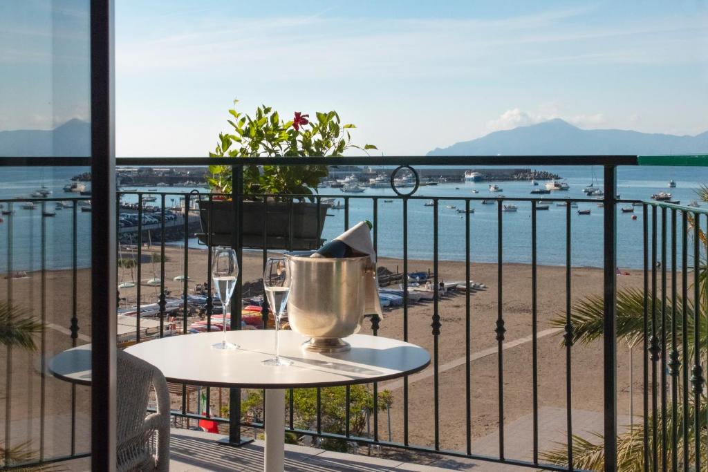 a table on a balcony with a view of the beach at Miramare Suites in Sestri Levante