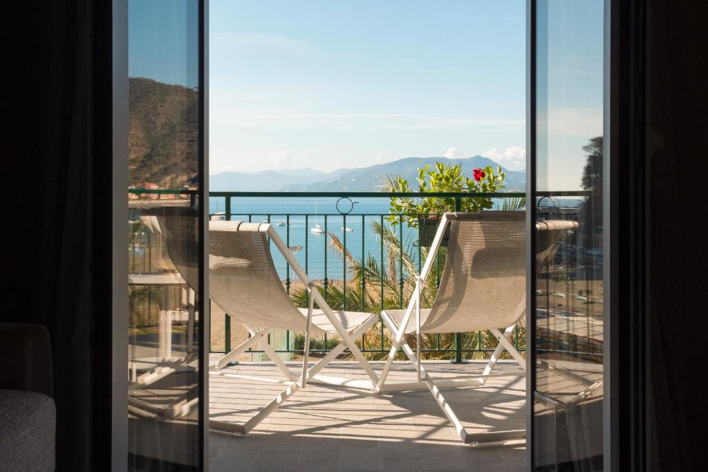 two chairs on a balcony with a view of the ocean at Miramare Suites in Sestri Levante