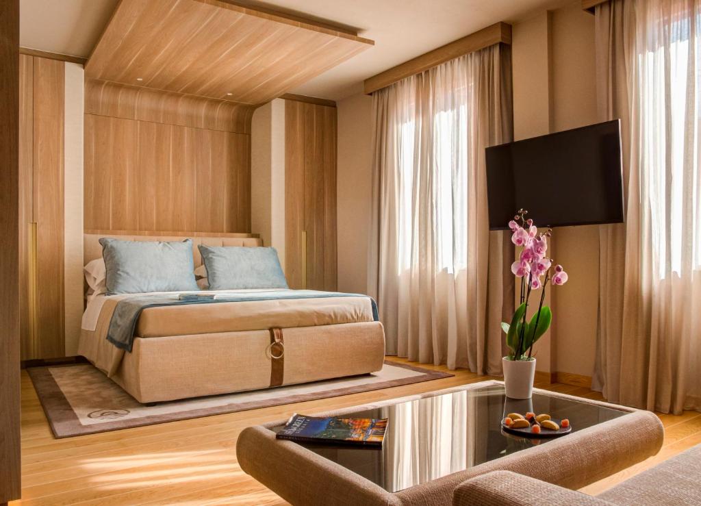 a bedroom with a bed and a couch and a table at Miramare Suites in Sestri Levante