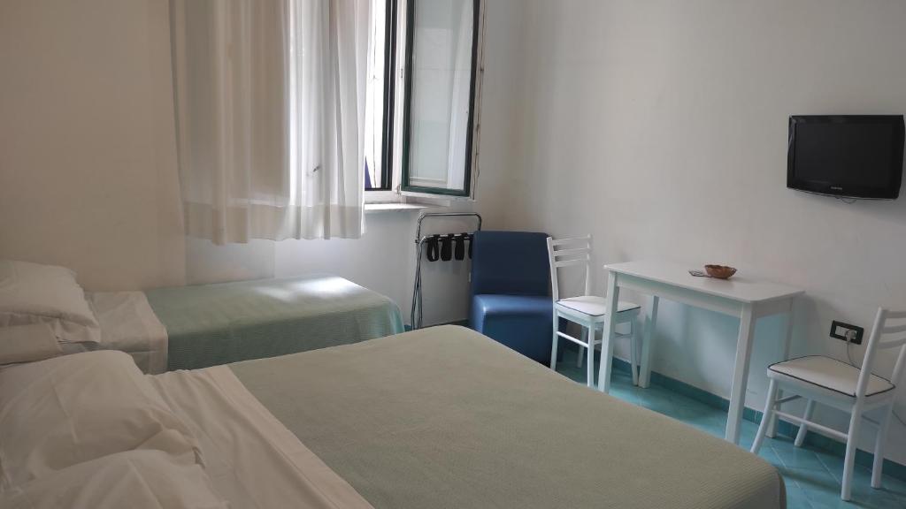 Postel nebo postele na pokoji v ubytování Albergo S. Andrea