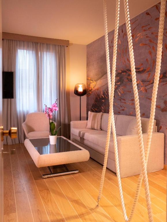 a living room with a couch and a swing at Miramare Suites in Sestri Levante