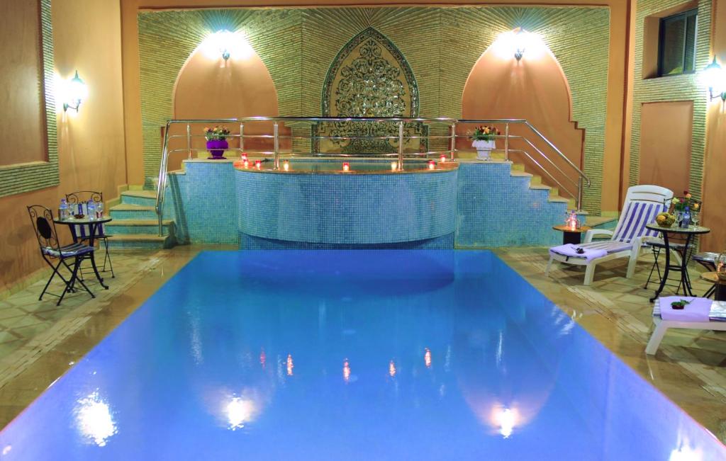 
a large swimming pool in a hotel room at Residence Hotel Assounfou in Marrakesh
