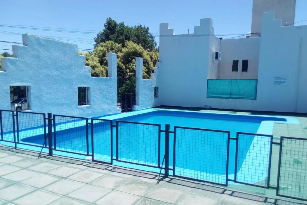 a swimming pool on the roof of a building at Castillo del Lago Carlos Paz - Solo Familiar in Villa Carlos Paz