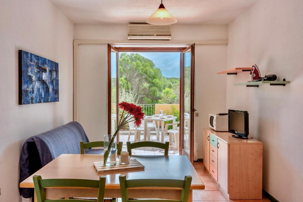 a dining room with a table and chairs and a window at Apartments in Santa Teresa di Gallura in Santa Teresa Gallura