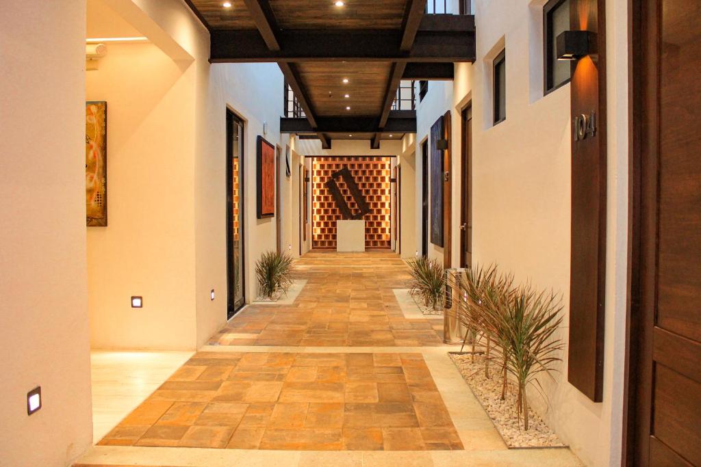 a hallway of a building with wooden ceilings and a long corridor at Hotel Casa Cantera in Oaxaca City