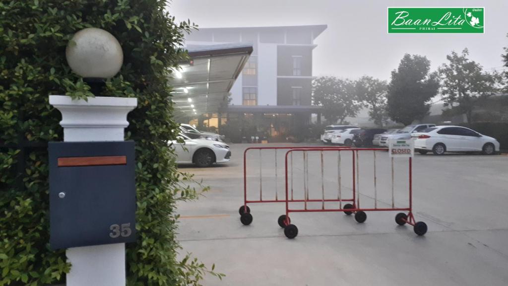 a shopping cart parked in a parking lot at Baan Lita in Pi Mai