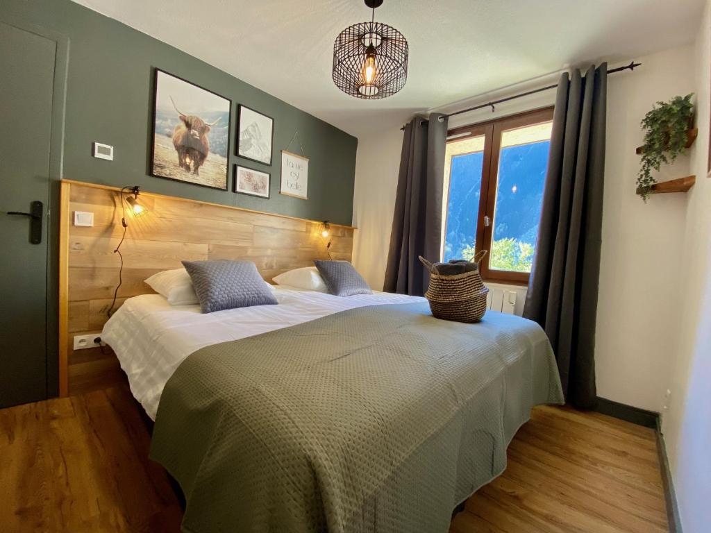 a bedroom with two beds and a window at La Cascade, Venosc - Les 2 Alpes in Vénosc