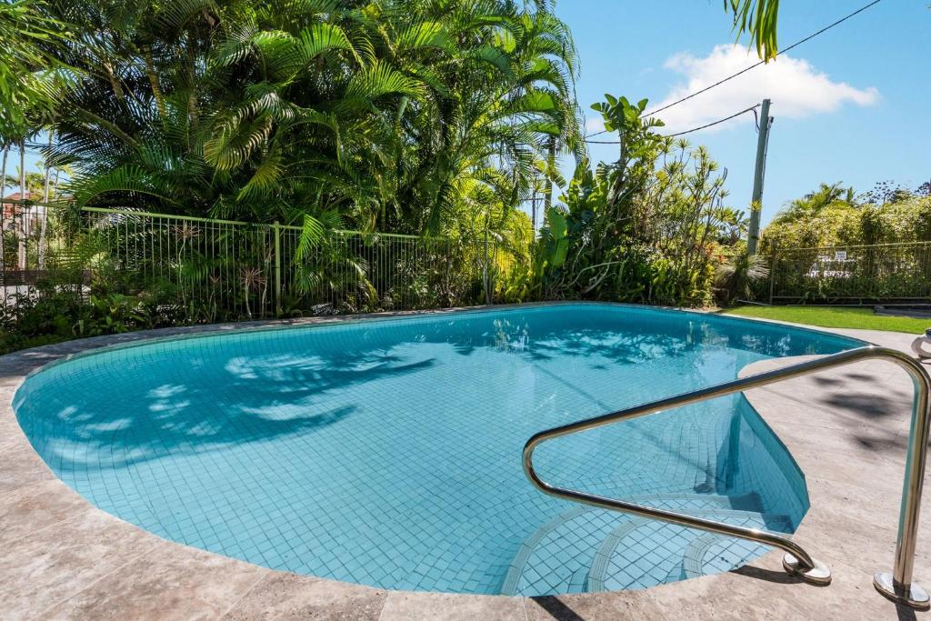 a swimming pool with a metal rail in a yard at Sundown Lodge 2 Edgar Bennett Avenue 14 in Noosa Heads