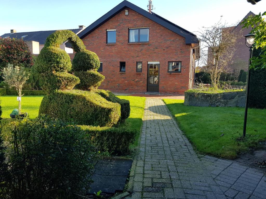 a bush shaped like rabbits in front of a house at Lovely Holiday Home in Merksplas with Fenced Garden in Merksplas