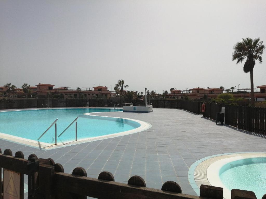a large swimming pool in a resort at Casa sol Origo Mare in Lajares