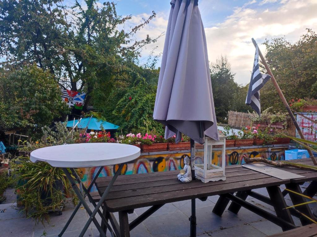 a table with an umbrella on top of it at One bedroom apartement with enclosed garden and wifi at Estinnes 