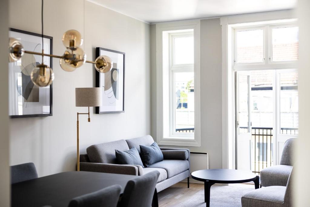 a living room with a couch and a table at Frogner House - Uranienborg in Oslo