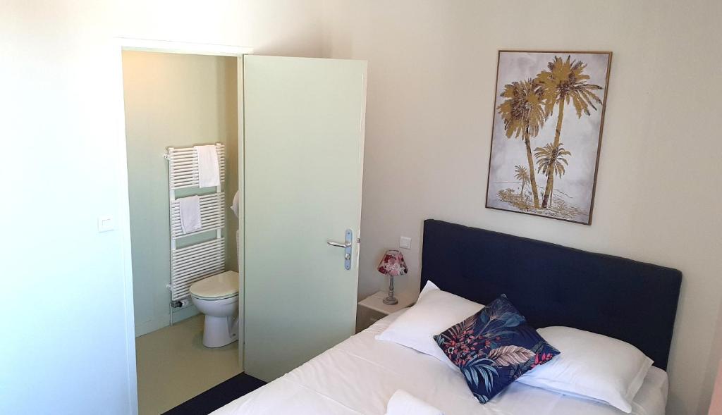 Postel nebo postele na pokoji v ubytování o'ptit hôtel