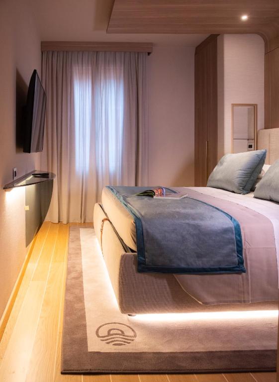 a bedroom with a large bed and a television at Miramare Suites in Sestri Levante