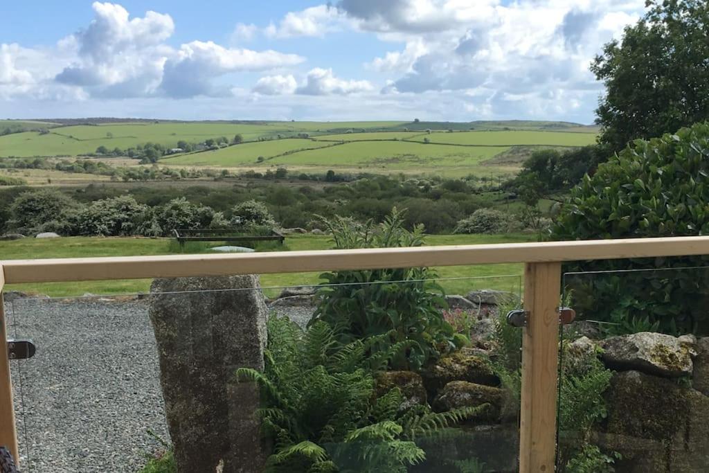 a view of the rolling hills from the balcony of a house at Skyber Barn, a rural retreat on Bodmin Moor in Liskeard
