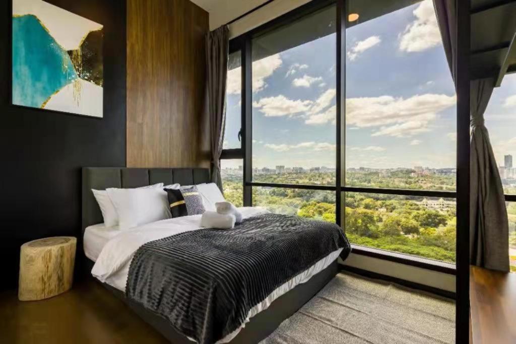 a bedroom with a bed and a large window at EUcation Home - Opus Residence in Kuala Lumpur