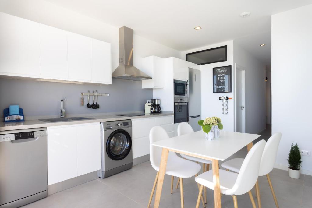 A kitchen or kitchenette at Home2Book Design & Breathtaking Sea Views El Porís