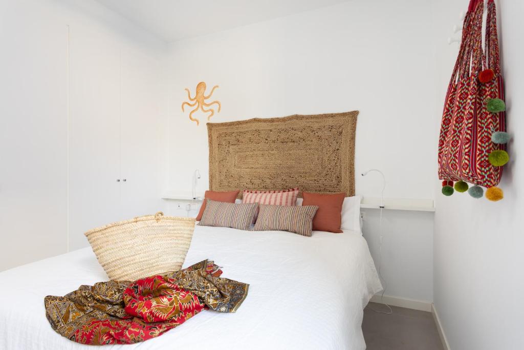 A bed or beds in a room at Home2Book Design & Breathtaking Sea Views El Porís