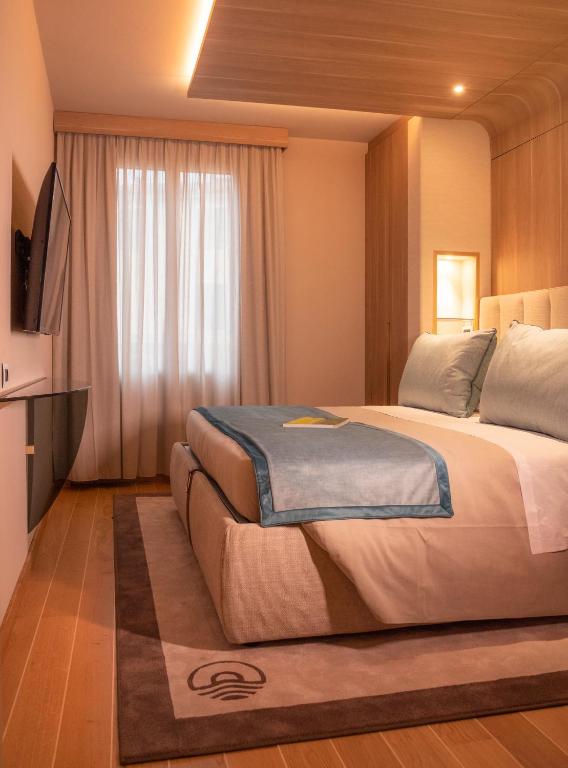 a bedroom with a large bed and a window at Miramare Suites in Sestri Levante