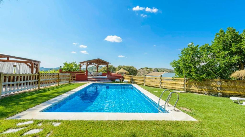 - une piscine dans une cour avec une clôture dans l'établissement Cortijo El Encinar de Cobo Martos by Ruralidays, à Fuensanta de Martos