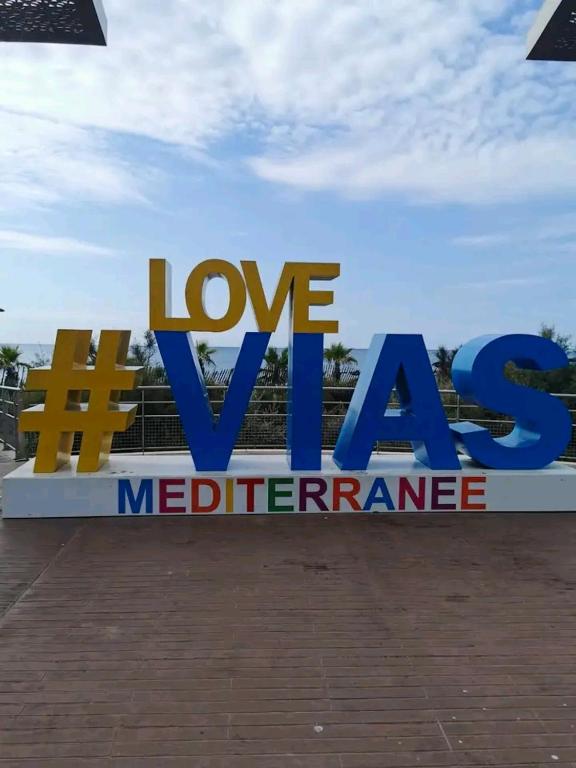 a sign that says love xa mediterraneanurance at Bungalow de 3 chambres avec piscine partagee et terrasse a Vias a 1 km de la plage in Vias