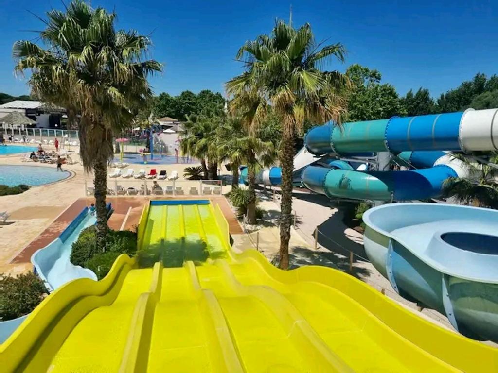 a water slide at a resort with a water park at Bungalow de 3 chambres avec piscine partagee et terrasse a Vias a 1 km de la plage in Vias