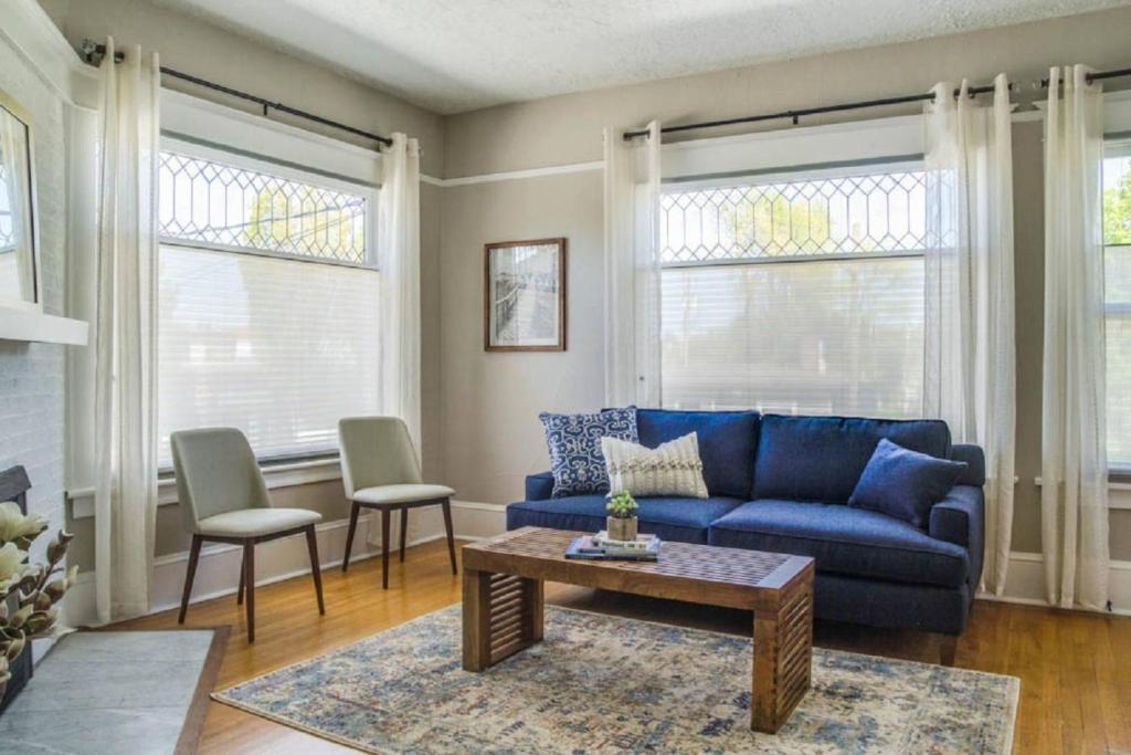 a living room with a blue couch and two chairs at Angel's Rest in Portland