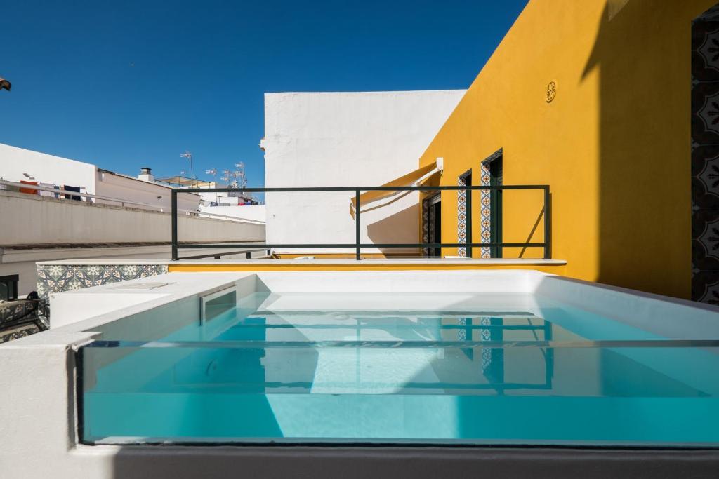 a swimming pool on the roof of a building at Wello Apartments Sevilla in Seville