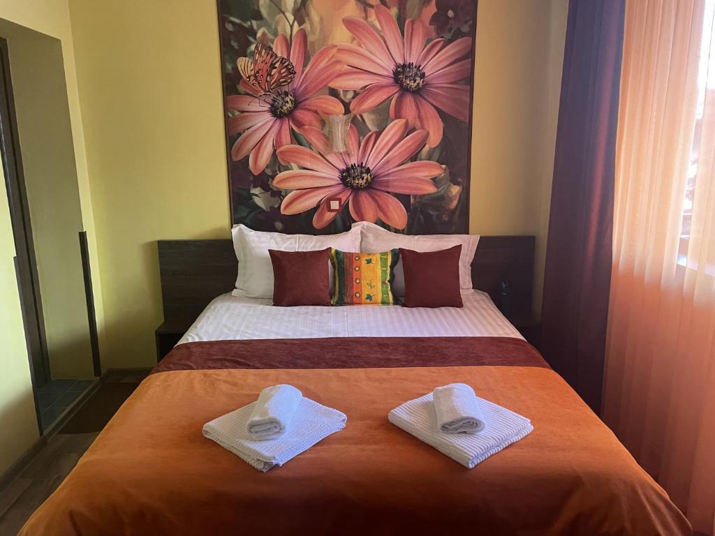 A bed or beds in a room at Asya Guest House