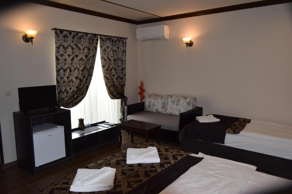 A bed or beds in a room at Asya Guest House