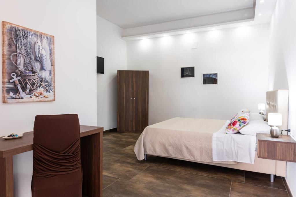 1 dormitorio con cama, mesa y escritorio en Benjoi Camere en SantʼArpino