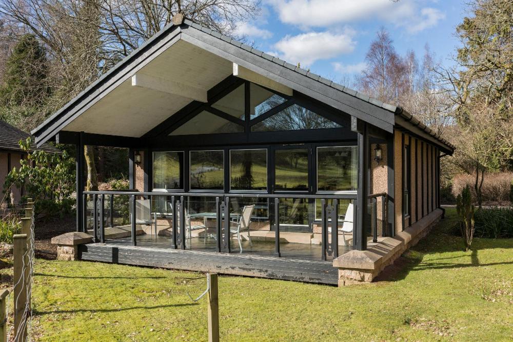 a large screened in porch of a house at Cameron House Lodges in Balloch