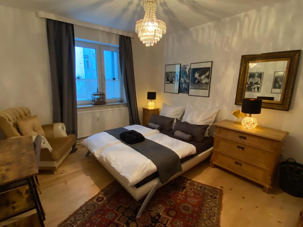 ein Schlafzimmer mit einem großen Bett und einem Kronleuchter in der Unterkunft Central City Privatapartment Relax-Inn, Netflix & Sky TV! in Hannover