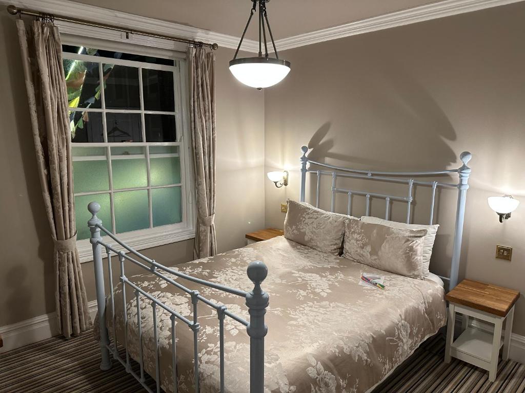 a bedroom with a blue bed and a window at The Beetroot in Margate