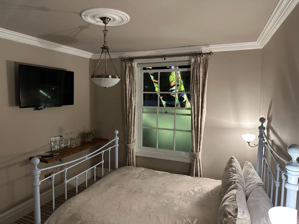 a bedroom with a bed and a window at The Beetroot in Margate