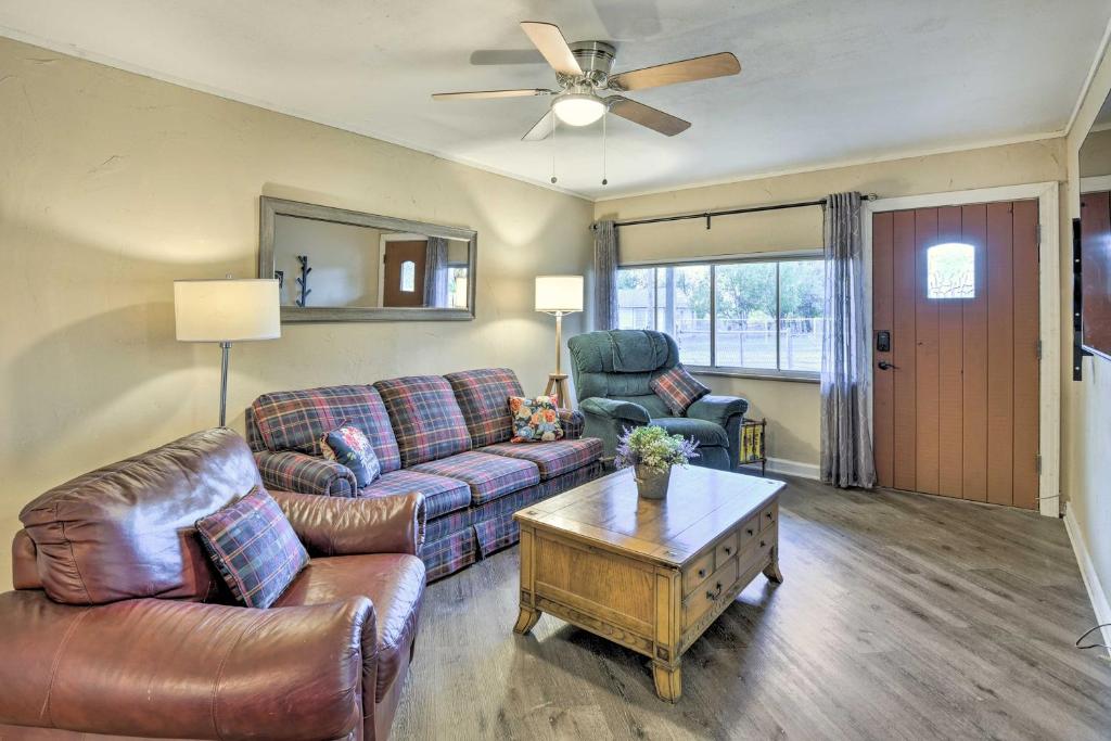 a living room with a couch and a table at Cozy Graham Retreat about 3 Mi to Lake Eddleman! in Graham