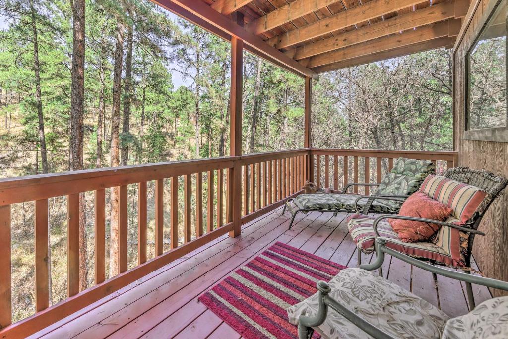 a screened in porch with two chairs and a rug at Dog-Friendly Alto Escape with Hot Tub and Foosball! in Alto