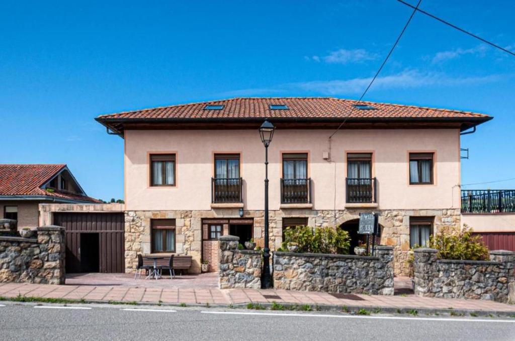 a large house with a stone wall at Casa Pinna in Santillana del Mar