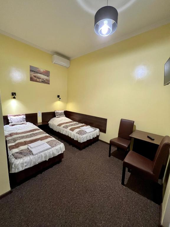 Posteľ alebo postele v izbe v ubytovaní Apartamenty Ostrowiec - Pokoje Gościnne Centrum