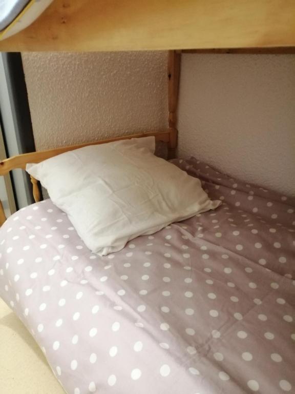 a bunk bed with a pillow and a pillowcase on it at petit nid montagnard in Rousset