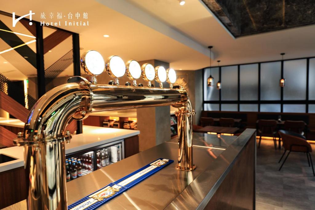 a bar in a restaurant with a sink with a mirror at Hotel Initial-Taichung in Taichung