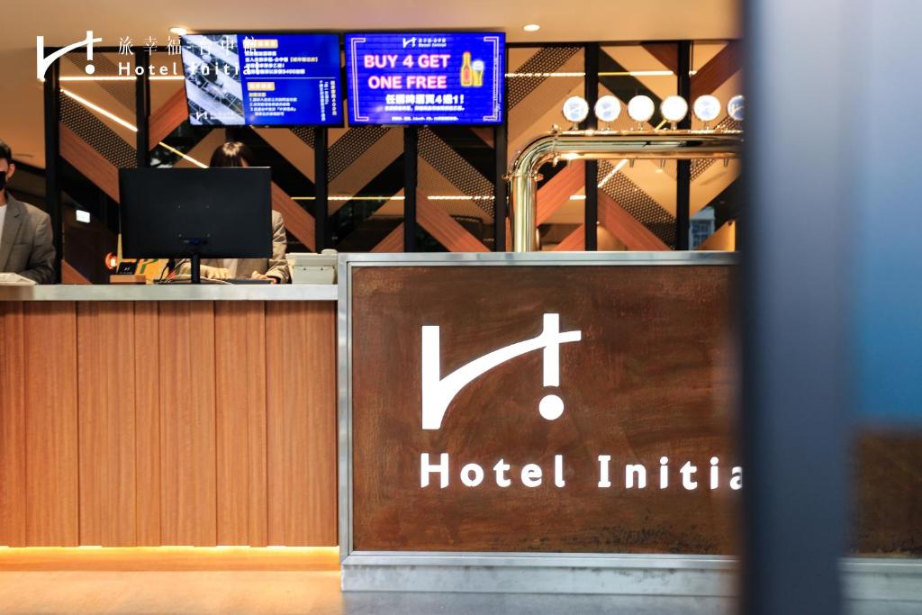 a hotel lobby with a sign for a hotel inside at Hotel Initial-Taichung in Taichung