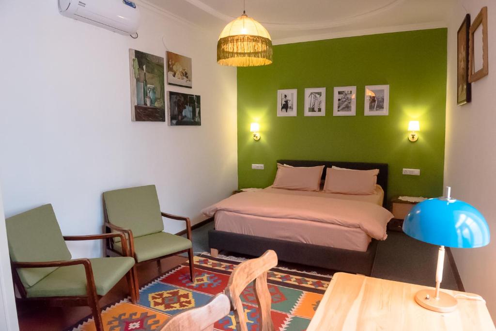 a bedroom with a bed and a table and chairs at Old Radio hostel in Samarkand