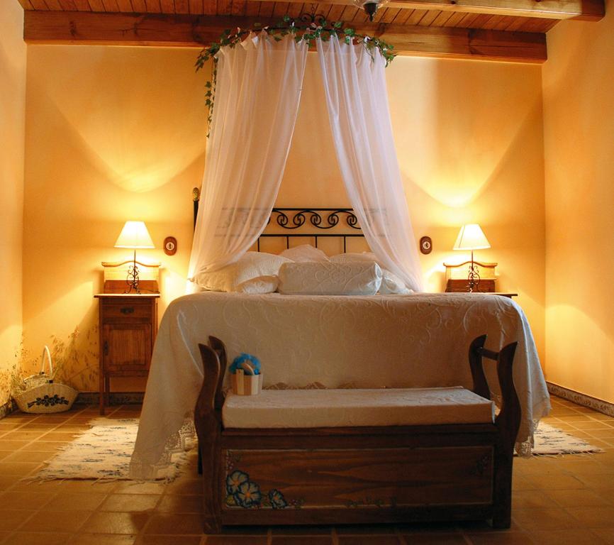a bedroom with a bed with a canopy at Casa Rural El Cañico in Otero de Bodas