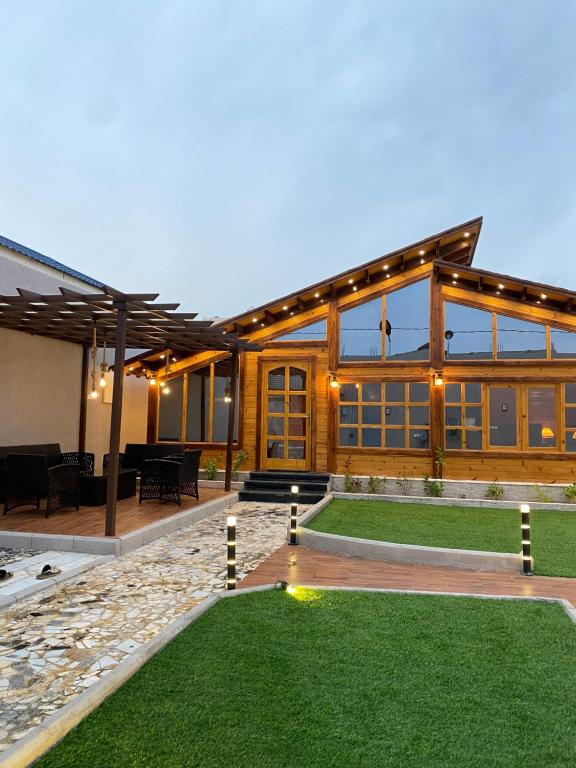 una grande casa con patio e prato di بلفيو كوخ a As Sayl aş Şaghīr
